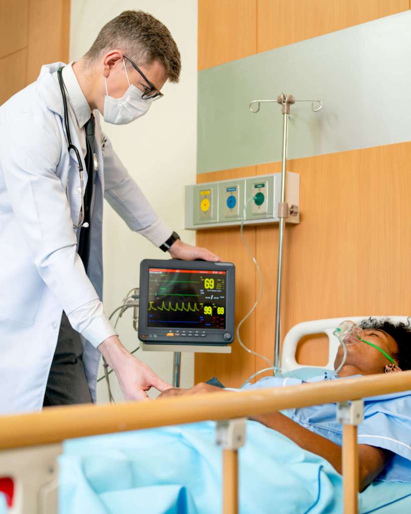Doctor and healthcare staff take care patient with emergency outcome in room and they also wearing hygiene mask try to treatment patient to get good result.